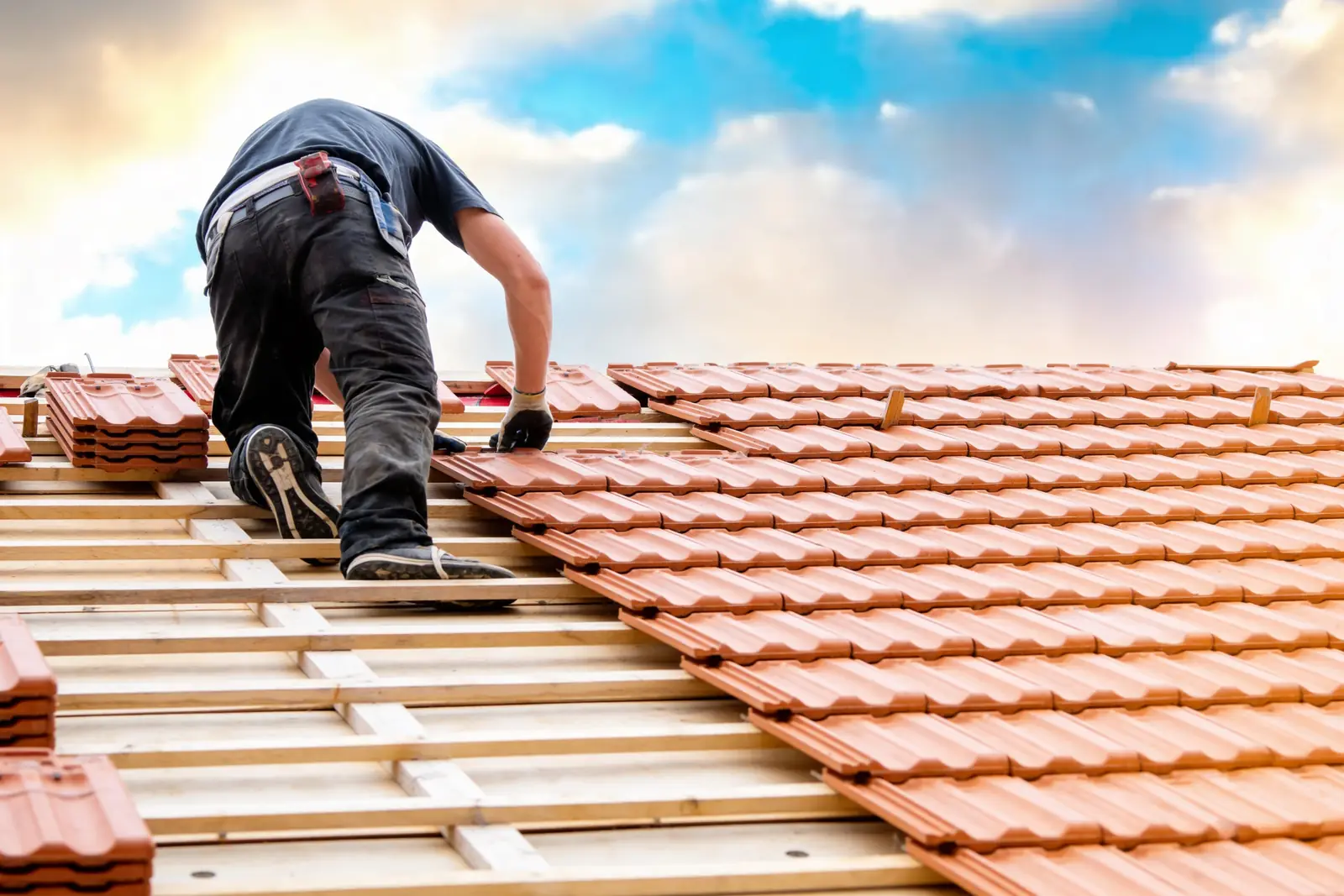 Roofing professional installing a new roof on a home